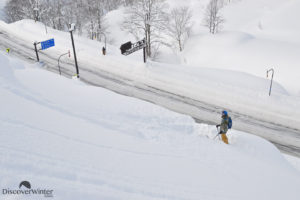 Jackson Sloss scoping his line after sending it off the avalanche barriers